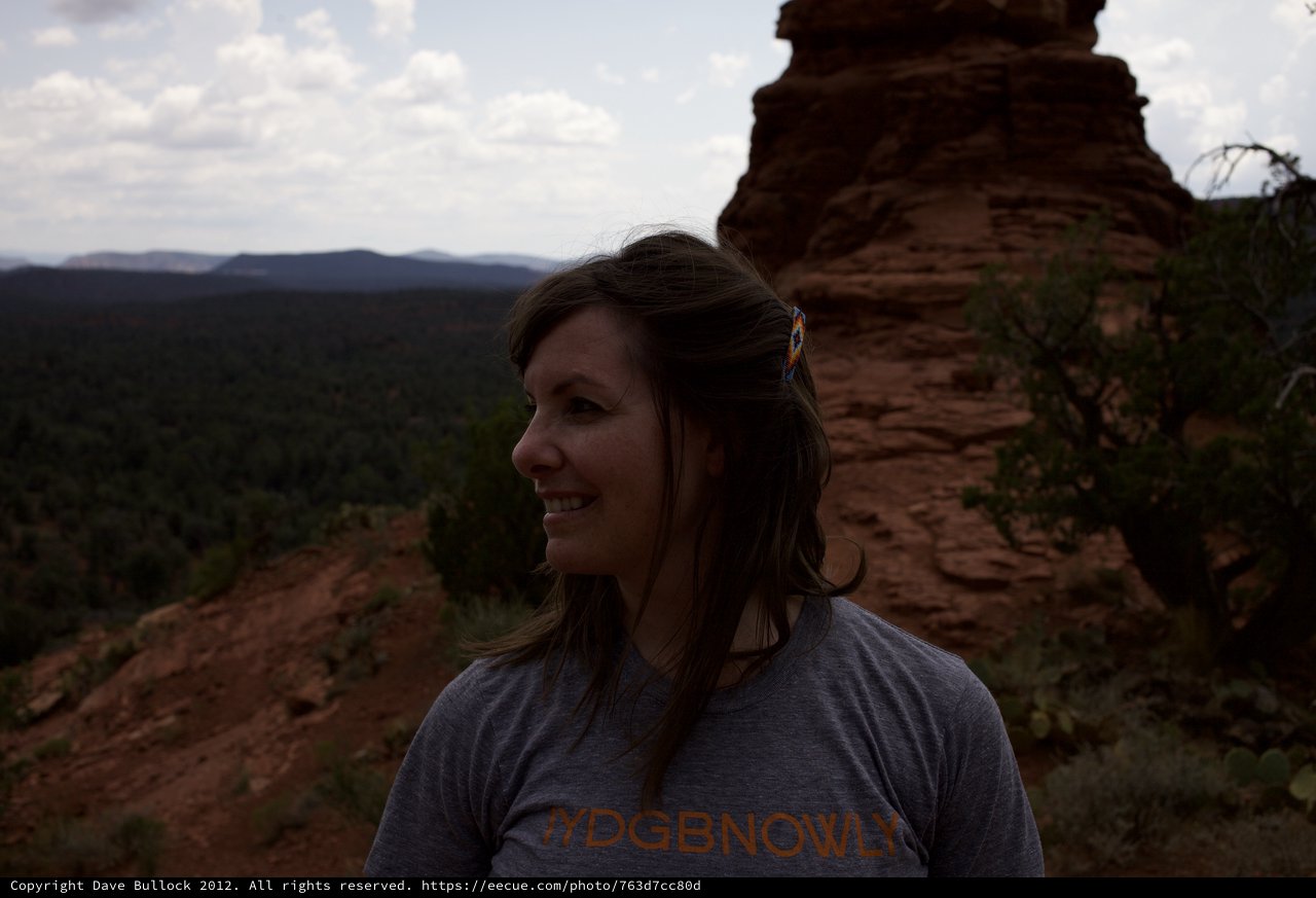 Woman Smiling Atop Red Rock Canyon Vista