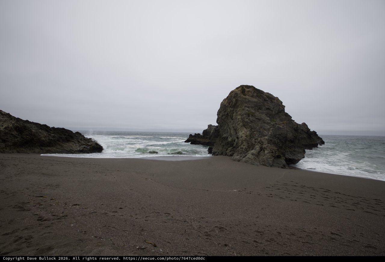 Moody Sea Stack on a Desolate Fog-Shrouded Beach