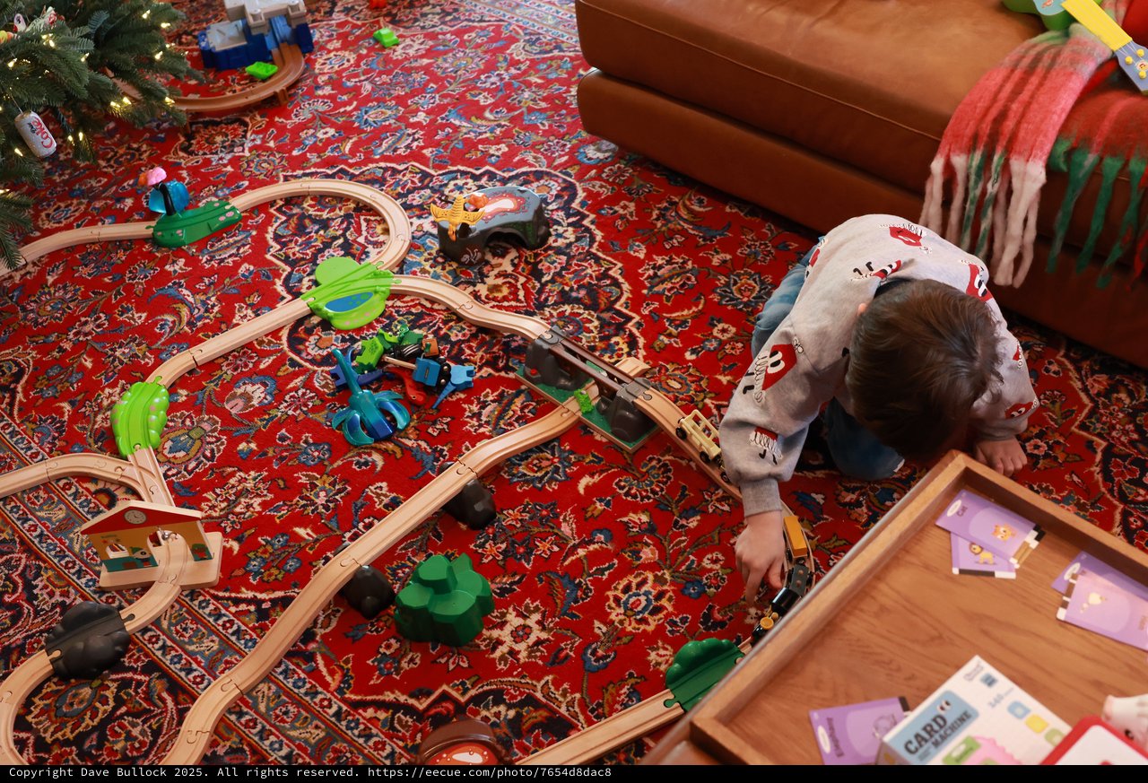 Child Playing with Wooden Train Set on Christmas Day
