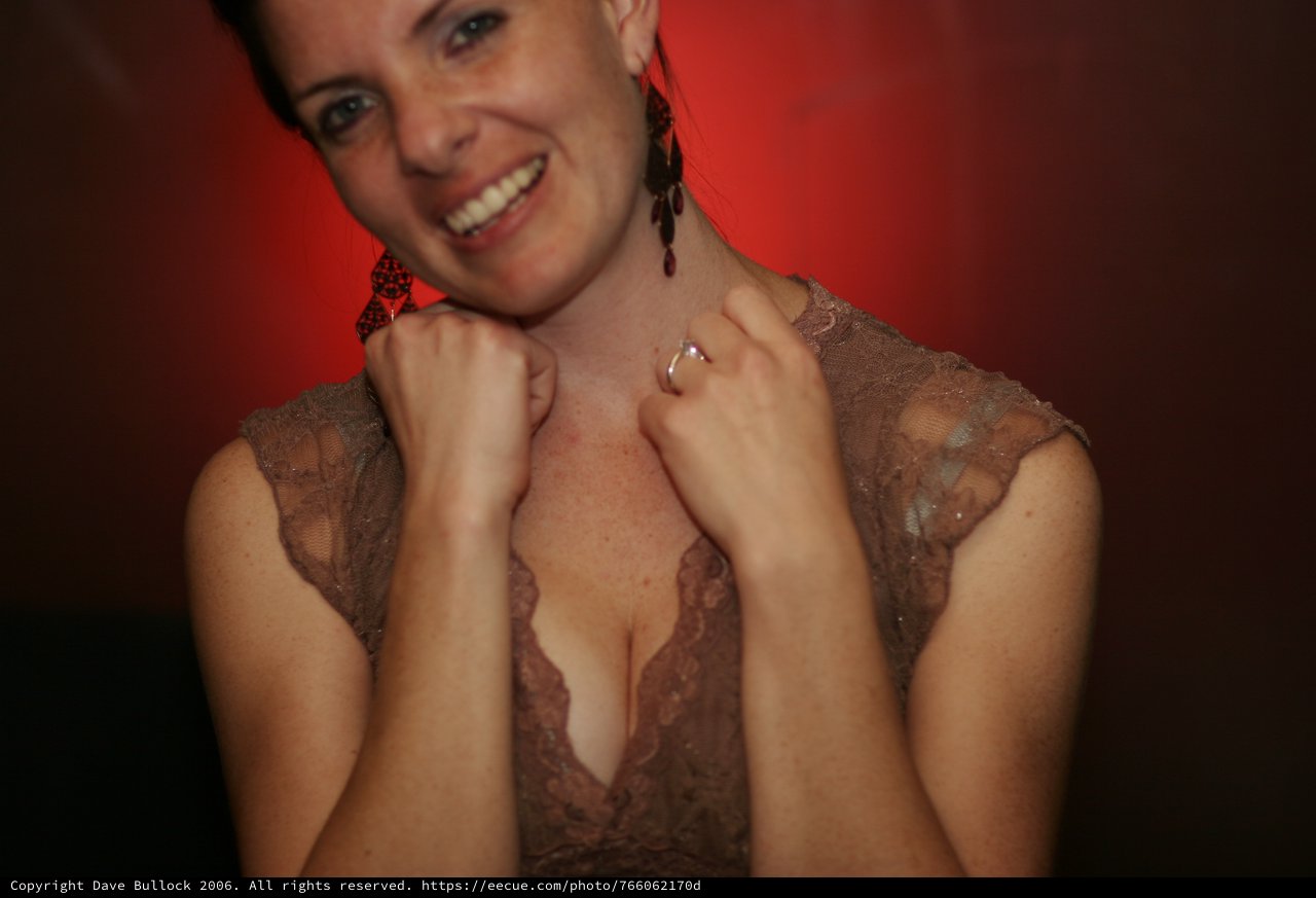 Smiling Woman in Lace Dress at Evening Event