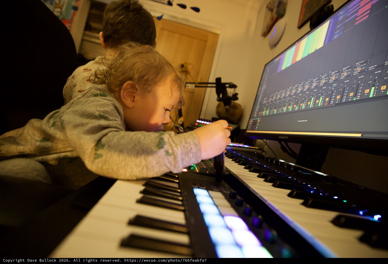 Young Child Learning Music Production with Parent