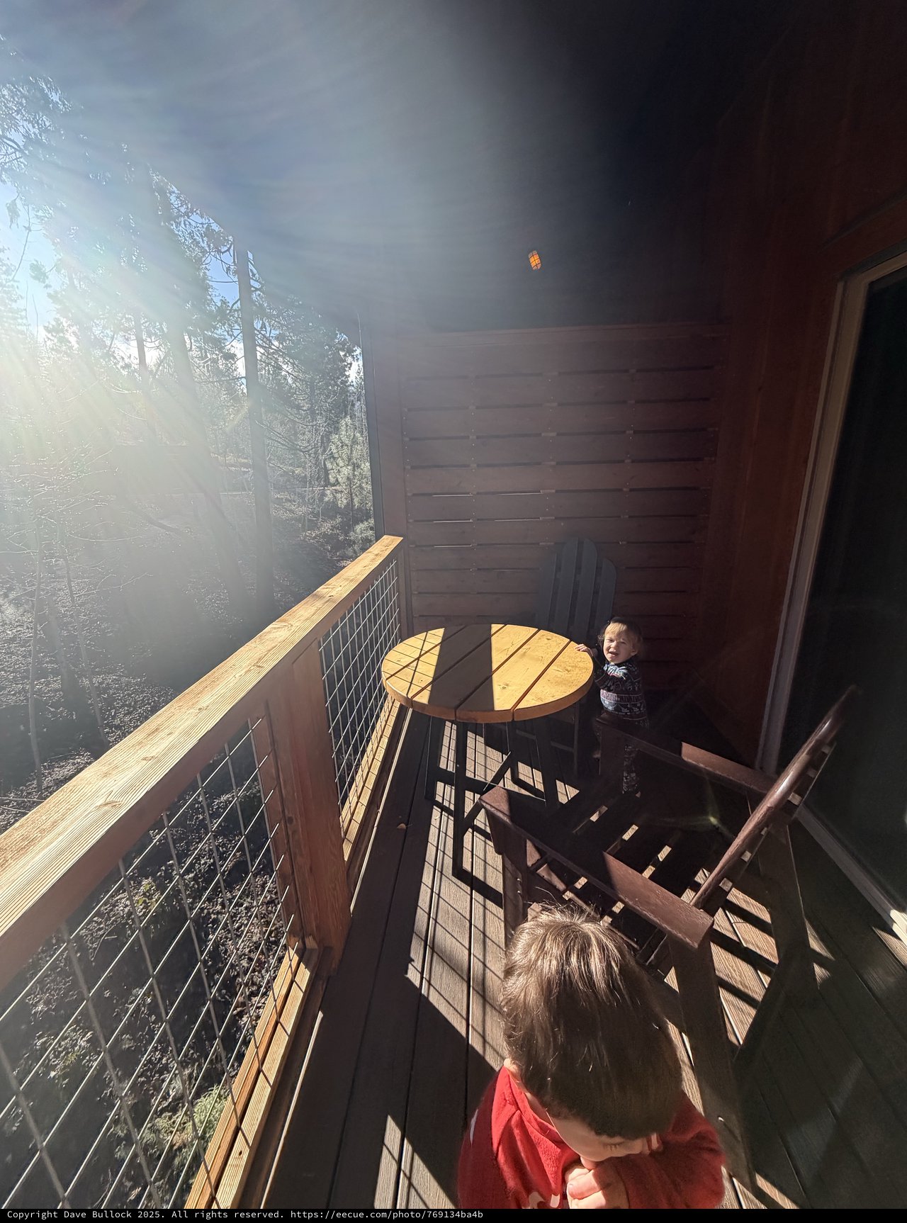 Children Exploring a Sunlit Cabin Deck in Yosemite