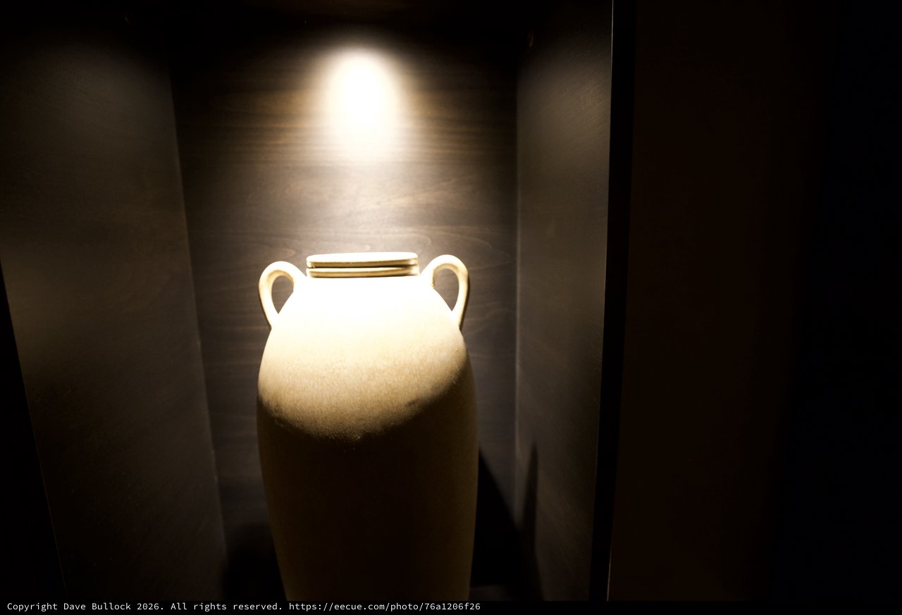 Illuminated White Amphora in Museum Display Niche