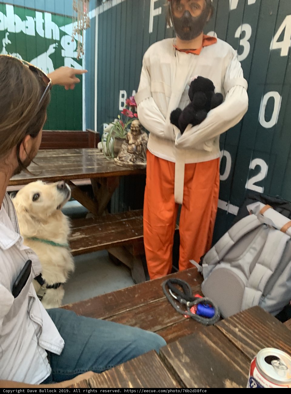 Orange Jumpsuit Man at Plywood Table