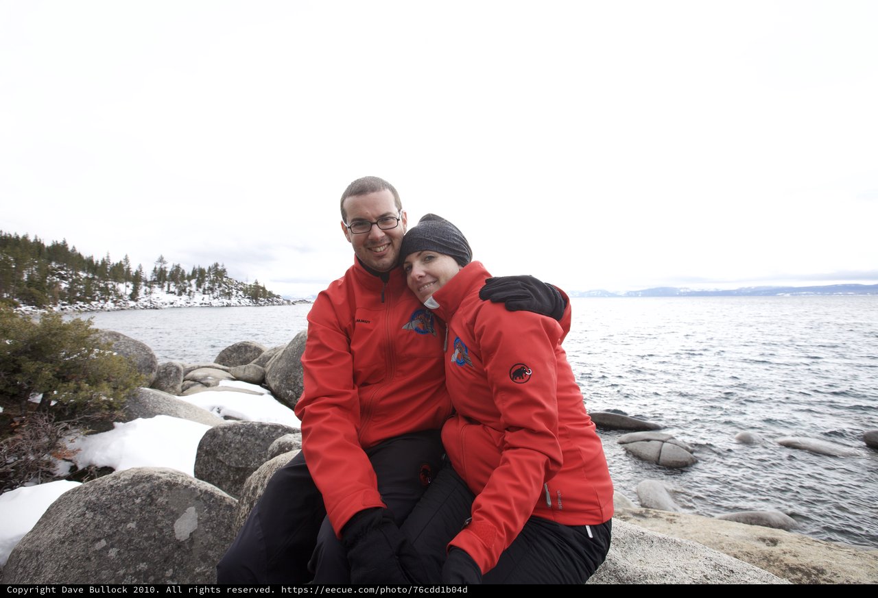 Couple Embracing at Snowy Lake Tahoe Shoreline