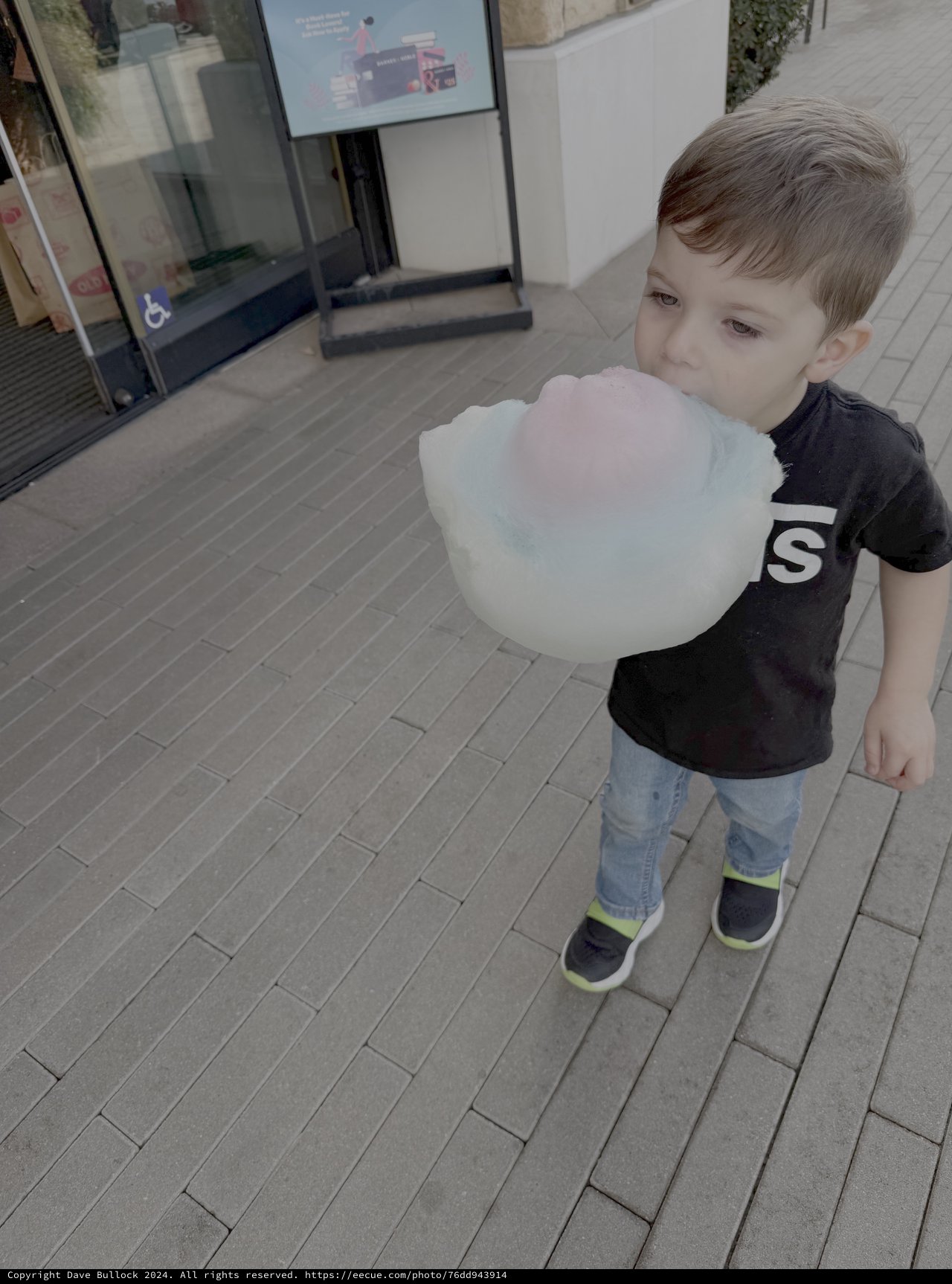 Young Boy Enjoying Cotton Candy Outdoors