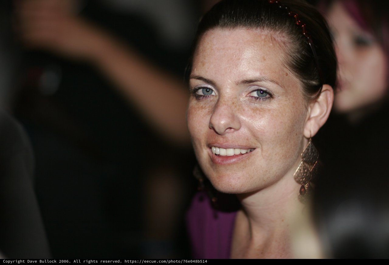 Smiling Woman with Blue Eyes at Evening Event