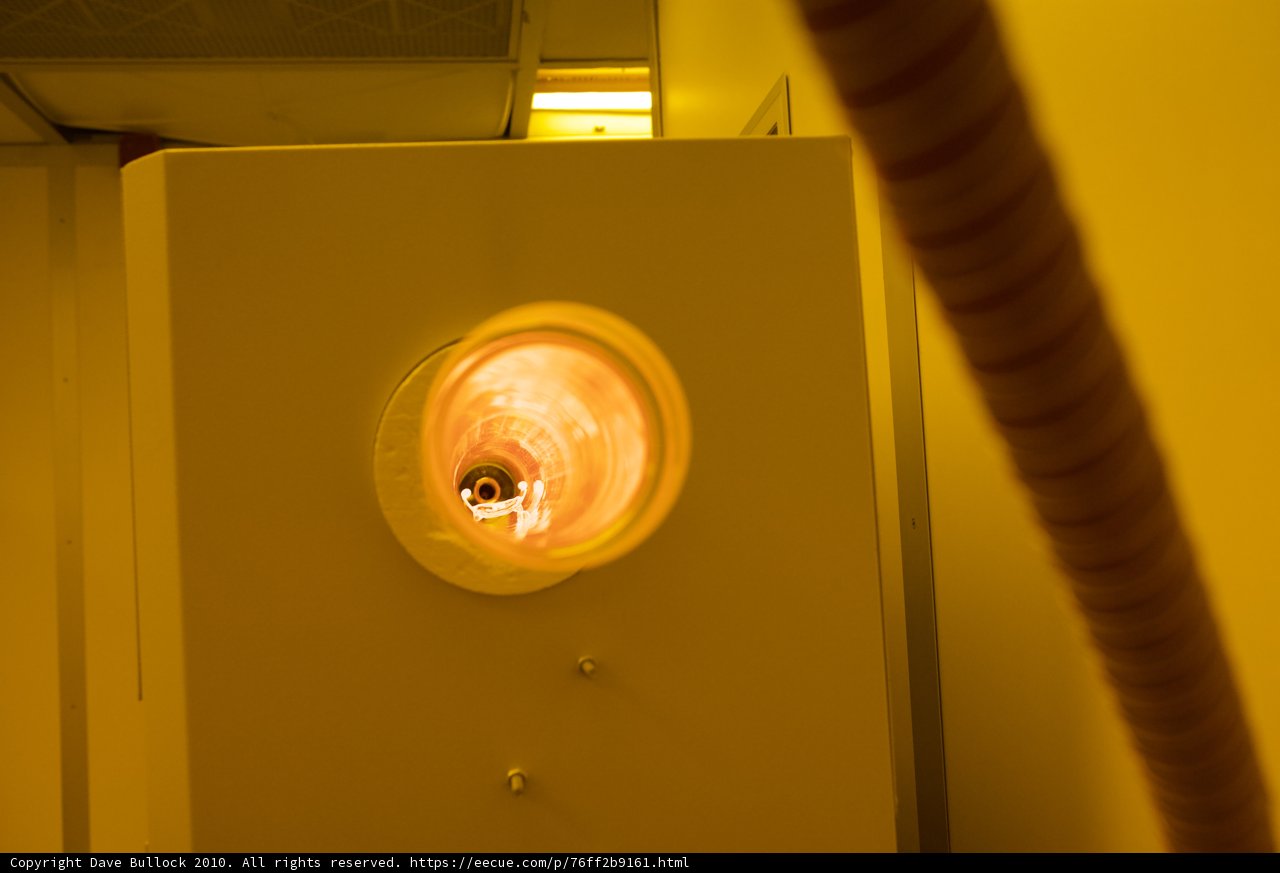 Illuminated Hole in White Wall