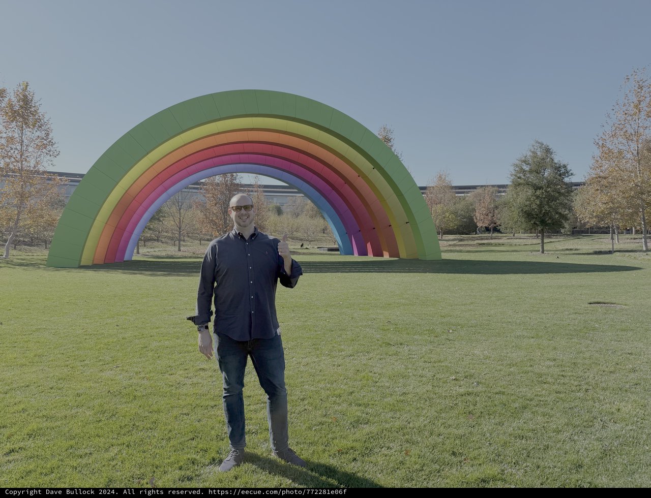Man Poses with Giant Rainbow Art Installation