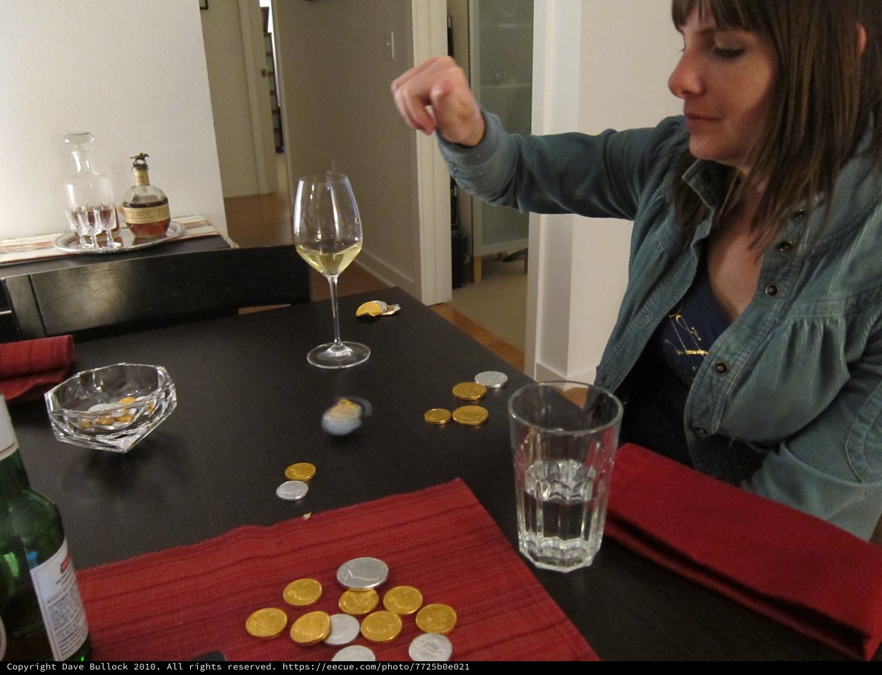 Woman Spinning Dreidel at Hanukkah Dinner Party