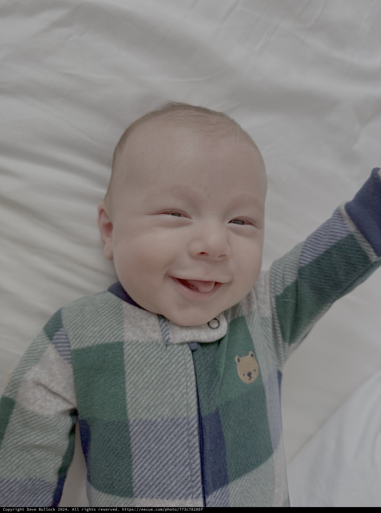 Smiling Baby in Colorful Striped Sleeper
