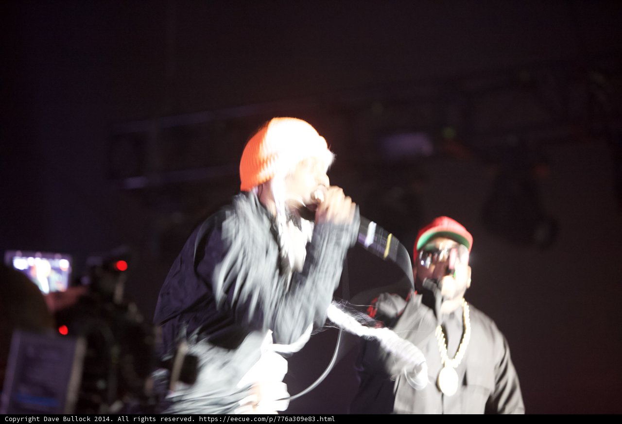 Men with Microphones and a Hat on Stage