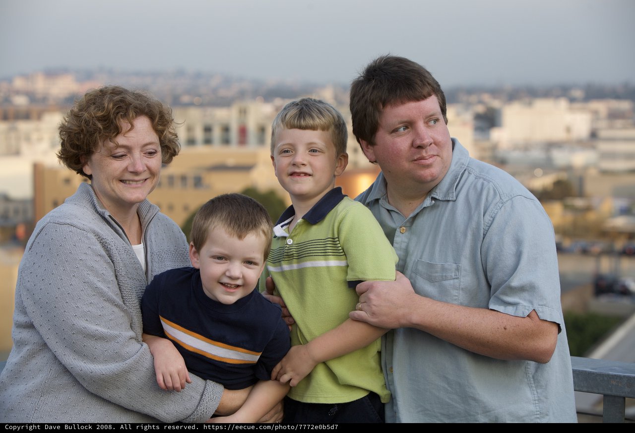 Family Portrait at Dusk with City Skyline