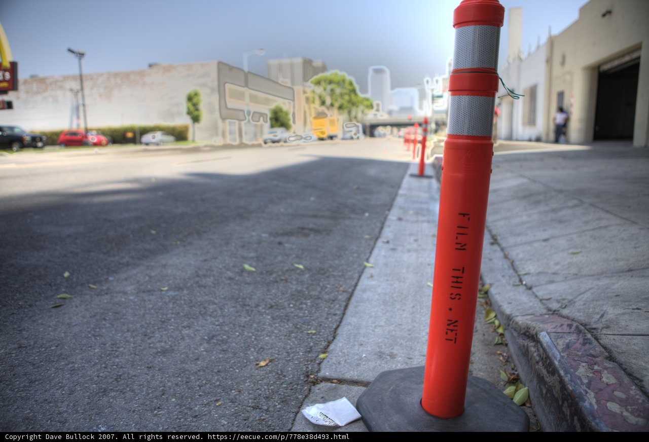 Red and White Traffic Cone in Urban Landscape