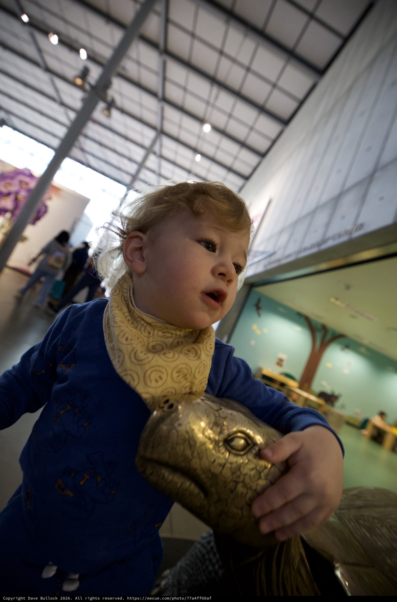 Child with Golden Turtle Sculpture at Museum