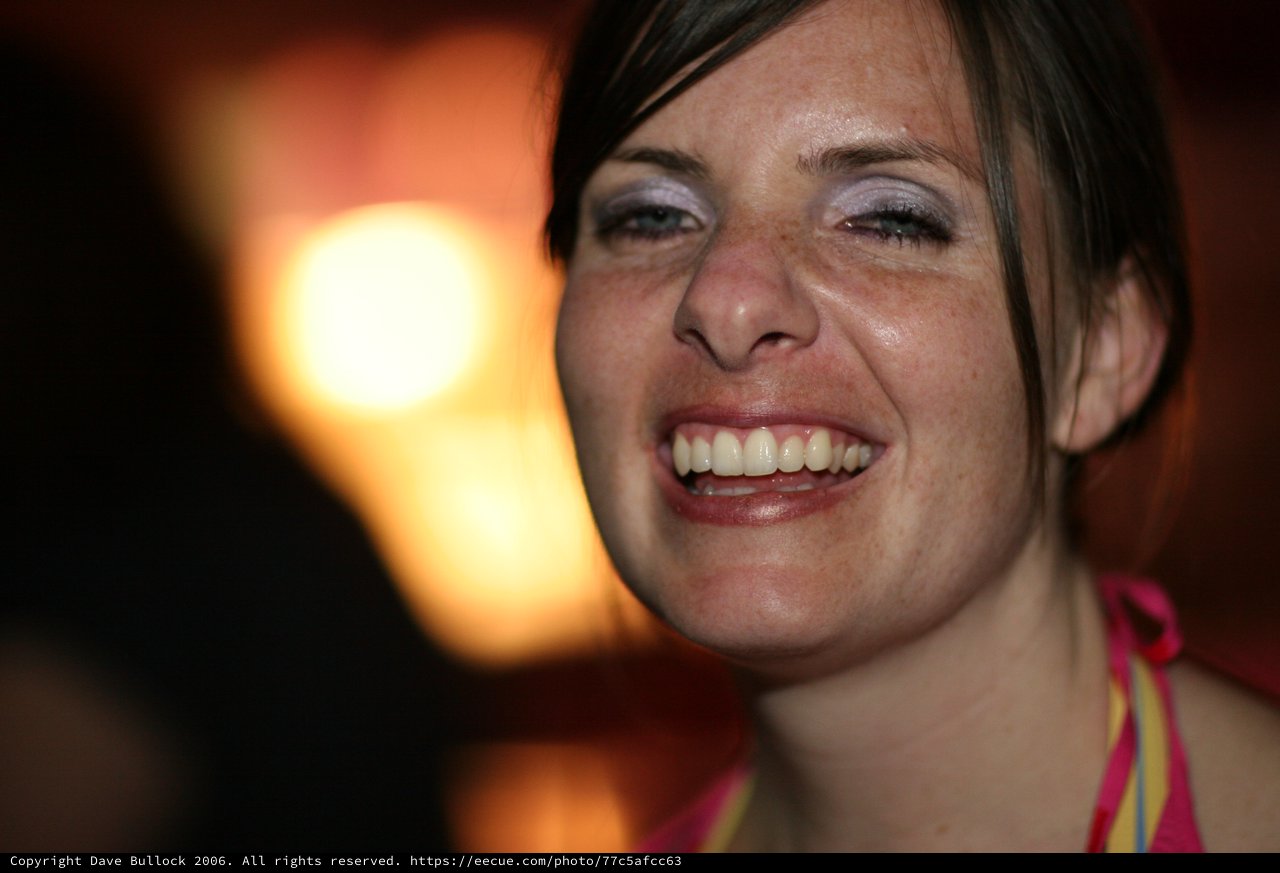 Penelope's Radiant Laugh in Warm Bokeh Light
