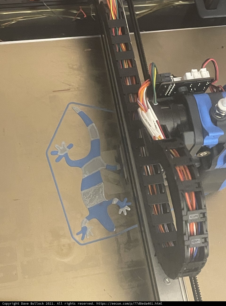 Futuristic 3D printer with a blue and white design