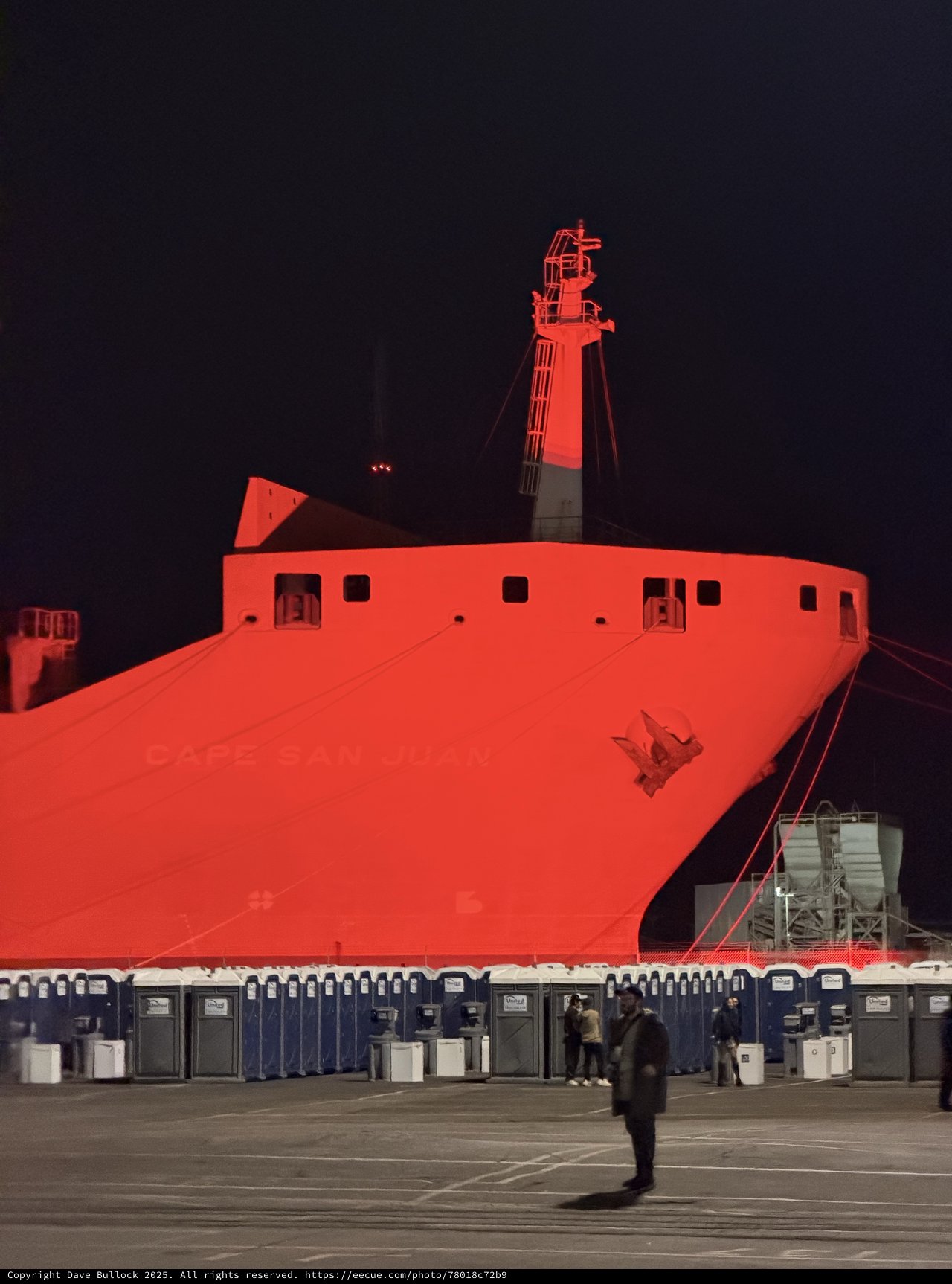 Massive Red-Lit Ship Hull at Night Event