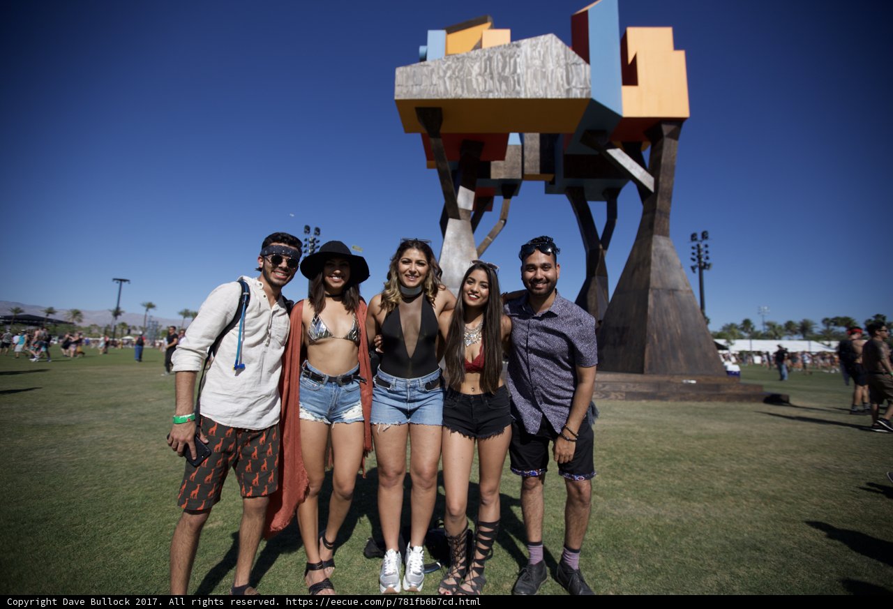 Four Friends Strike a Pose in Front of a Sculpture