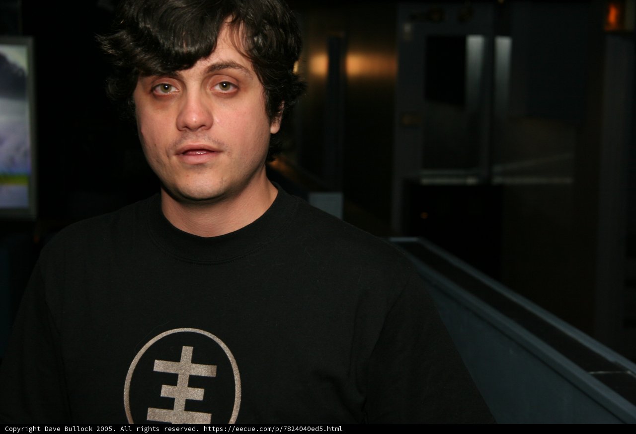 Alan W in Black T-Shirt Standing in Front of Television