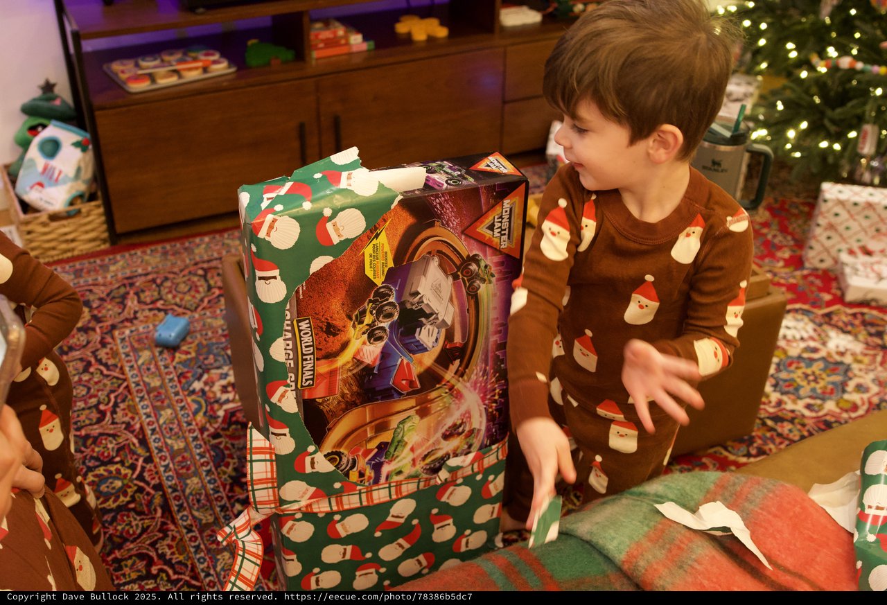 Young Boy Unwrapping Large Christmas Gift