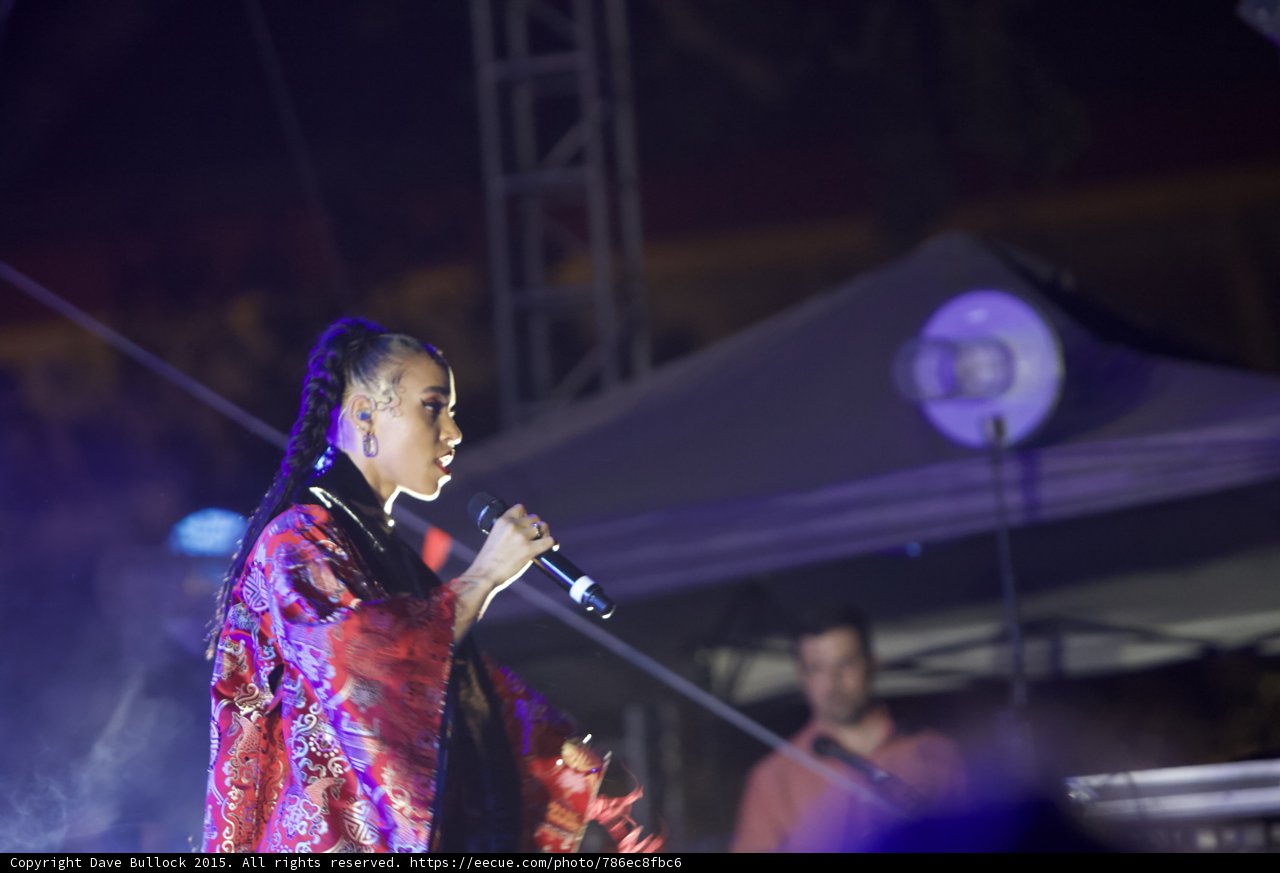 FKA twigs Upper Body Profile Singing Baby Hairs Swirls Hoop Earrings Red Lipstick Braided Ponytail Black Choker Kimono Red Brocade Gold Patterns Stage Truss Canopy Band Haze