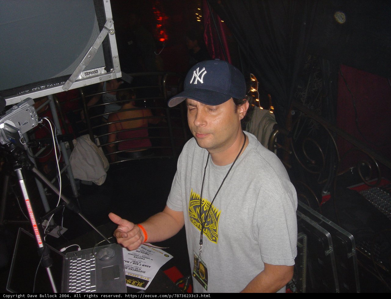 Grey-Shirted Man Sporting a Baseball Cap