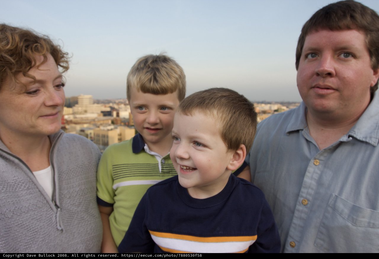 Family Portrait on a City Rooftop at Dusk