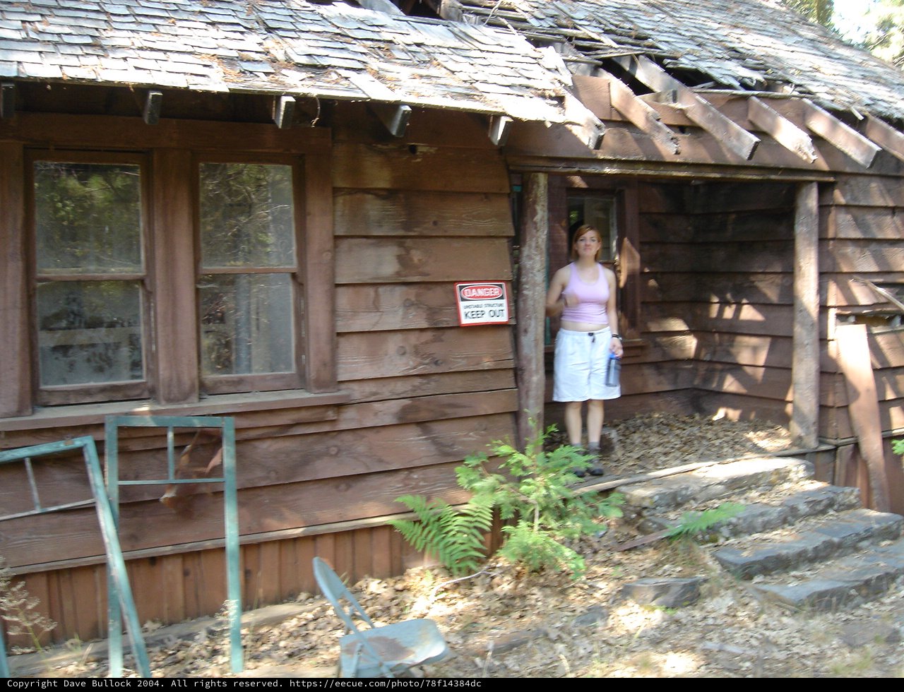 Young Woman Explores Dangerous Abandoned Wooden Cabin