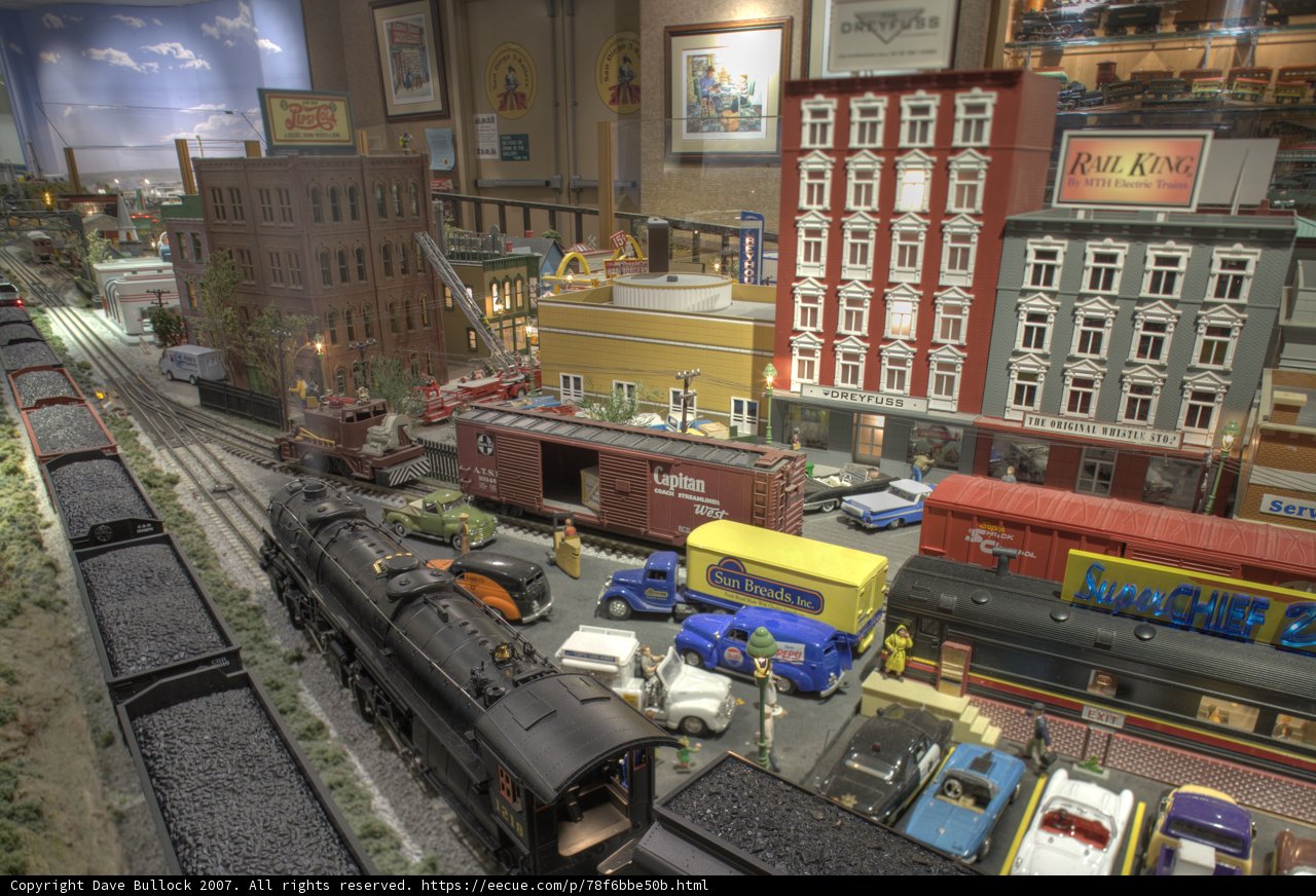 Miniature train and cars in a vibrant diorama