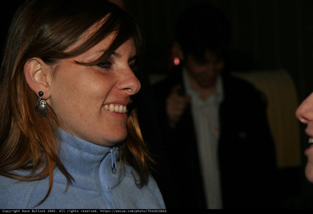 Smiling Woman in Blue Fleece at Evening Event