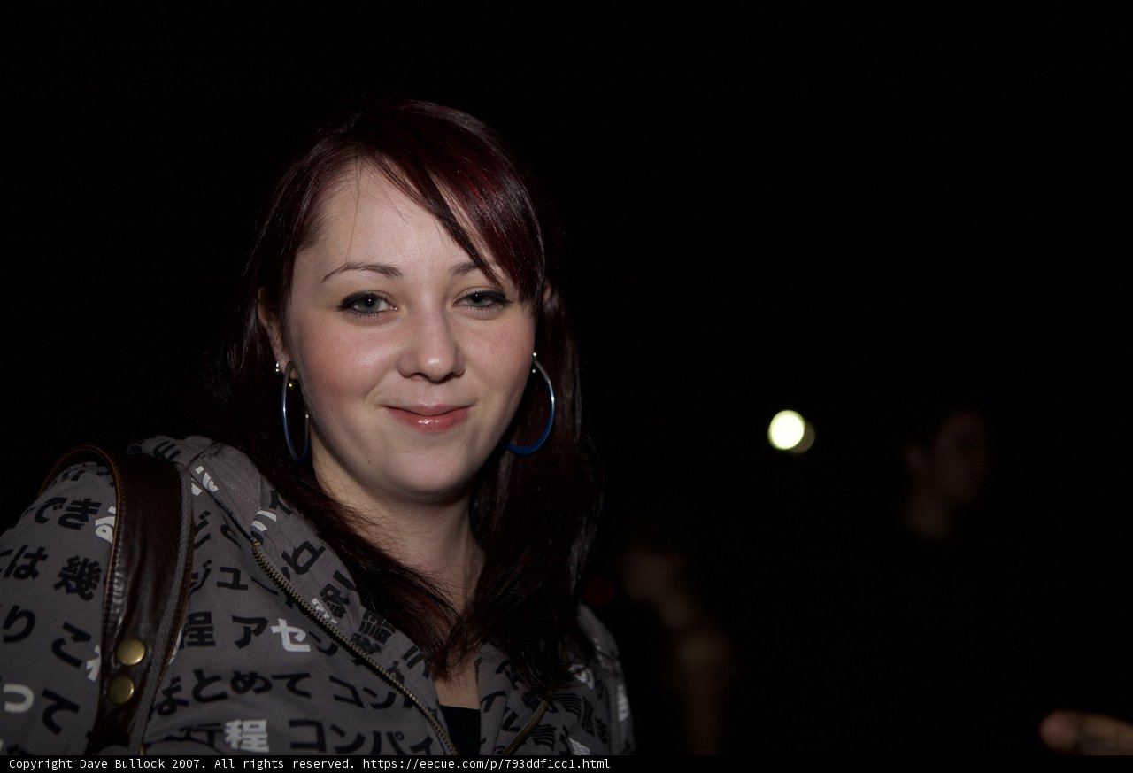 Red-Headed Woman Smiling in Black Jacket