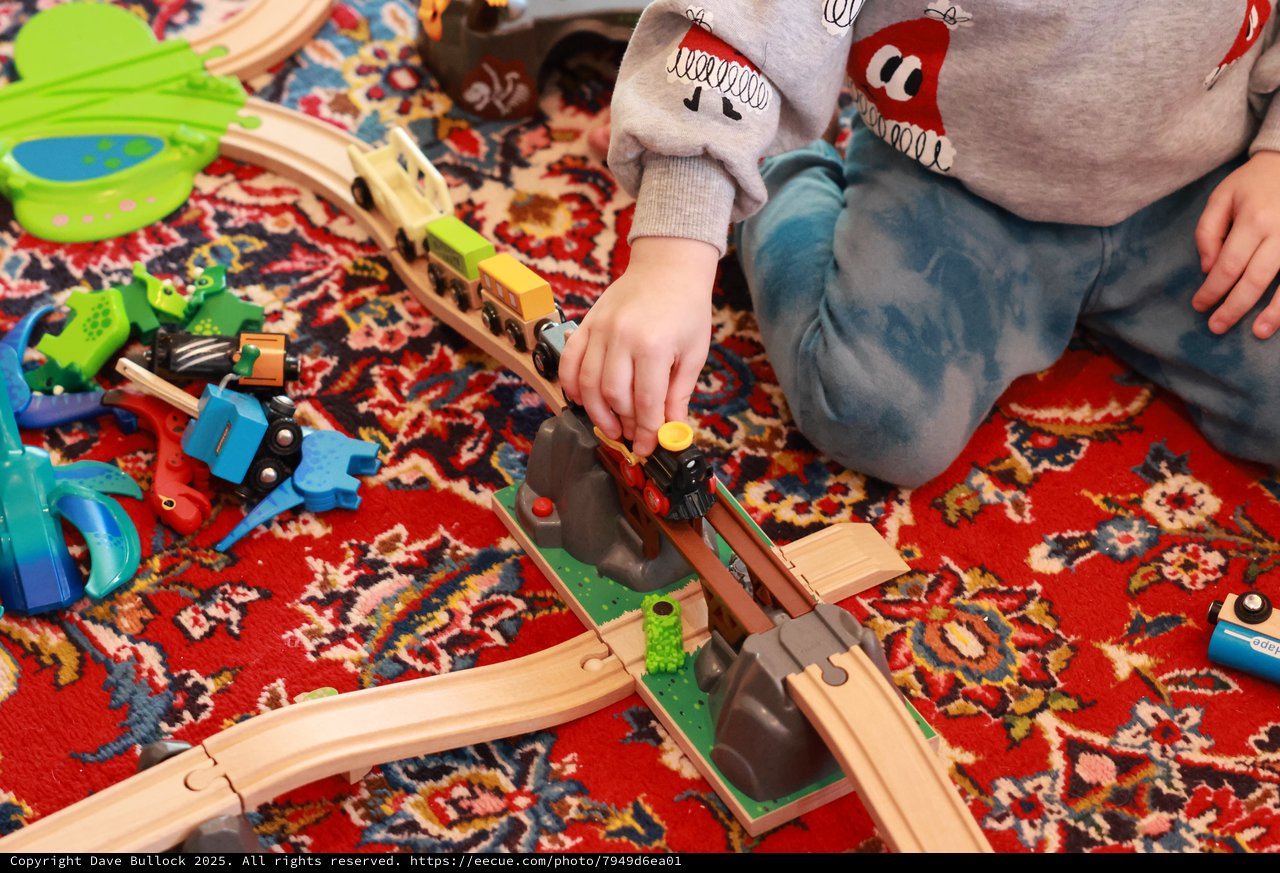 Child Playing with Wooden Train Set on Christmas Day