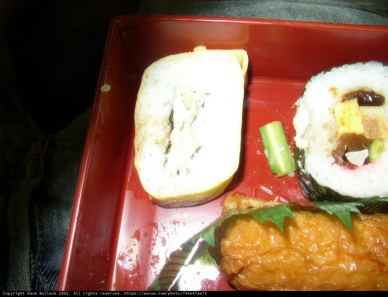 Appetizing Sushi Roll and Fresh Vegetables on a Red Tray