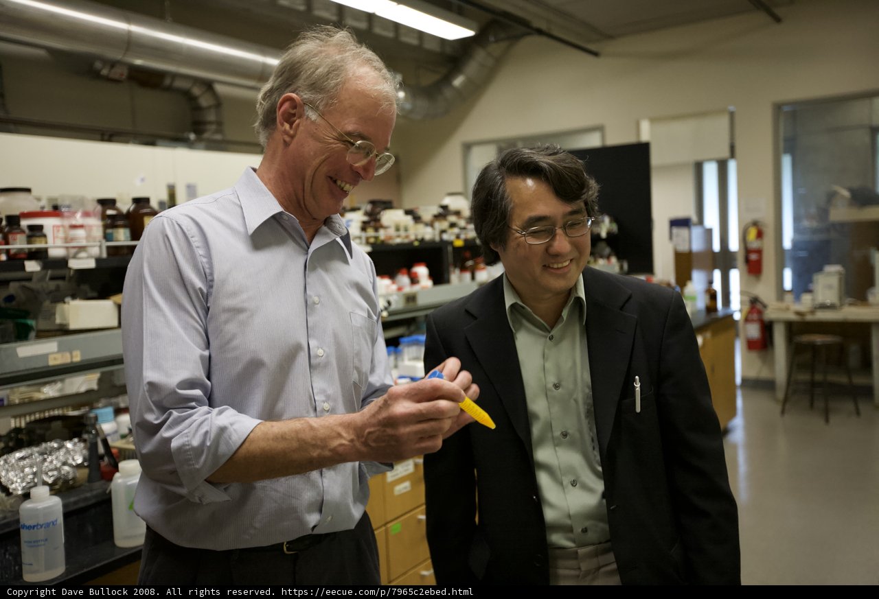 Two Men Conducting Nanomachine Research in Lab