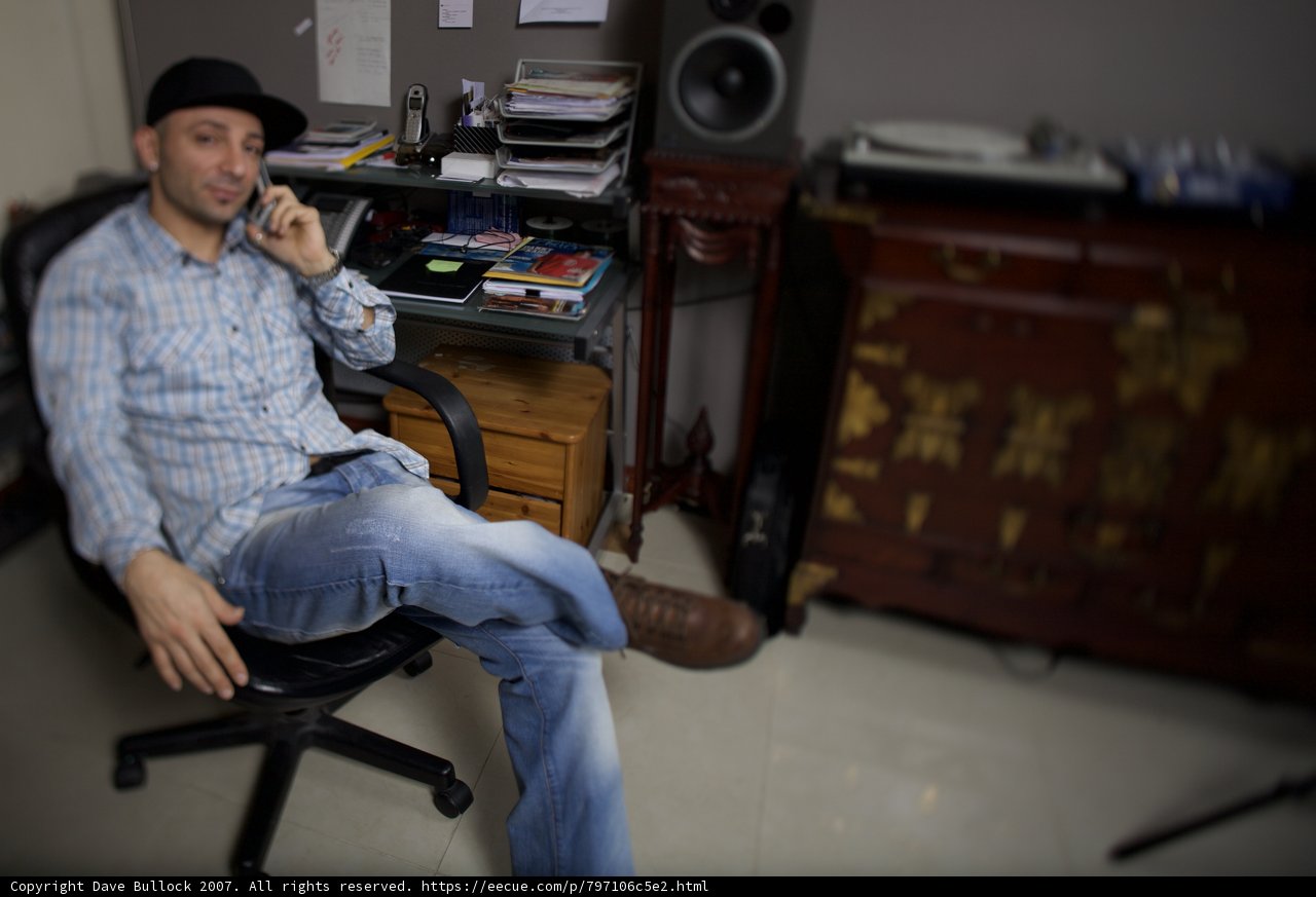 Man sitting in swivel chair in living room