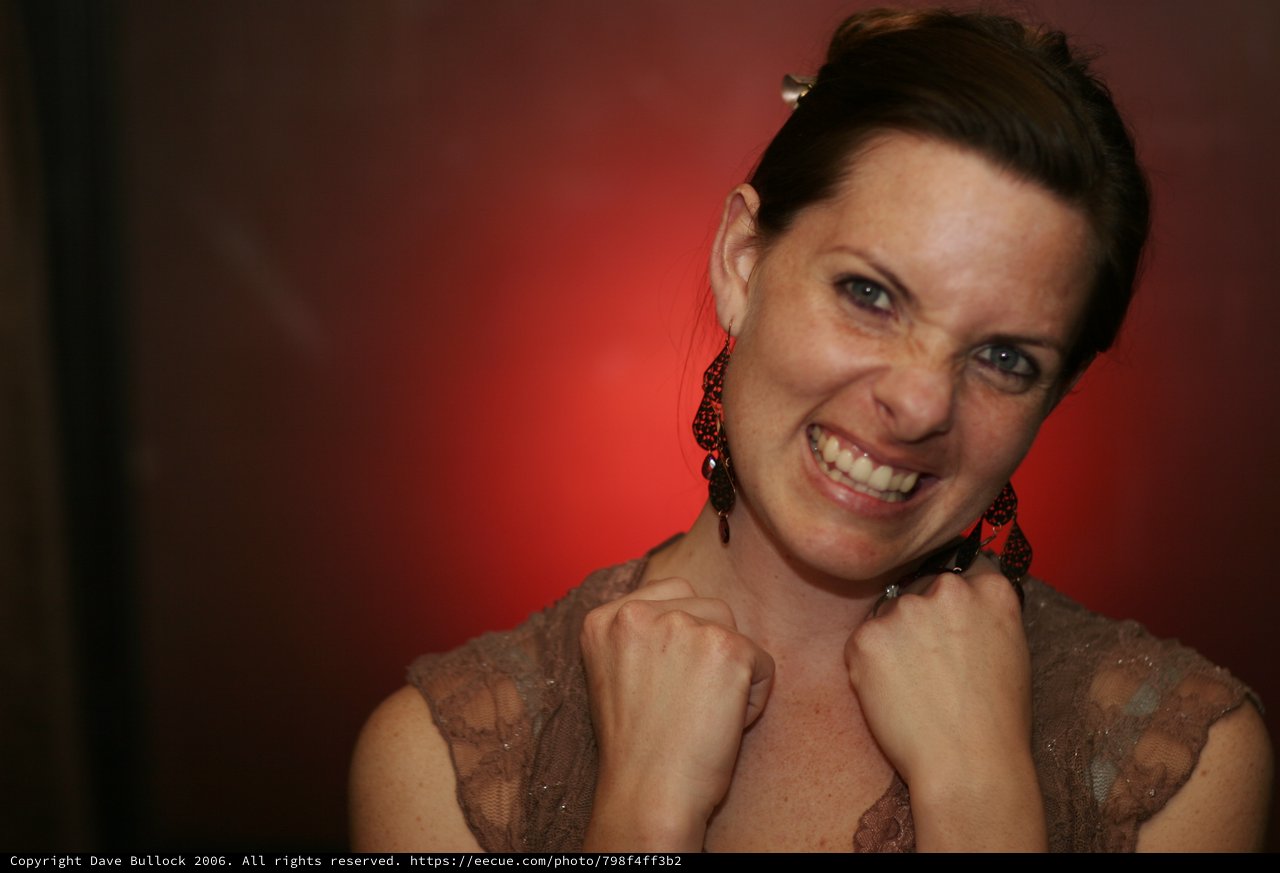 Woman Celebrates with Fierce Grin and Raised Fists