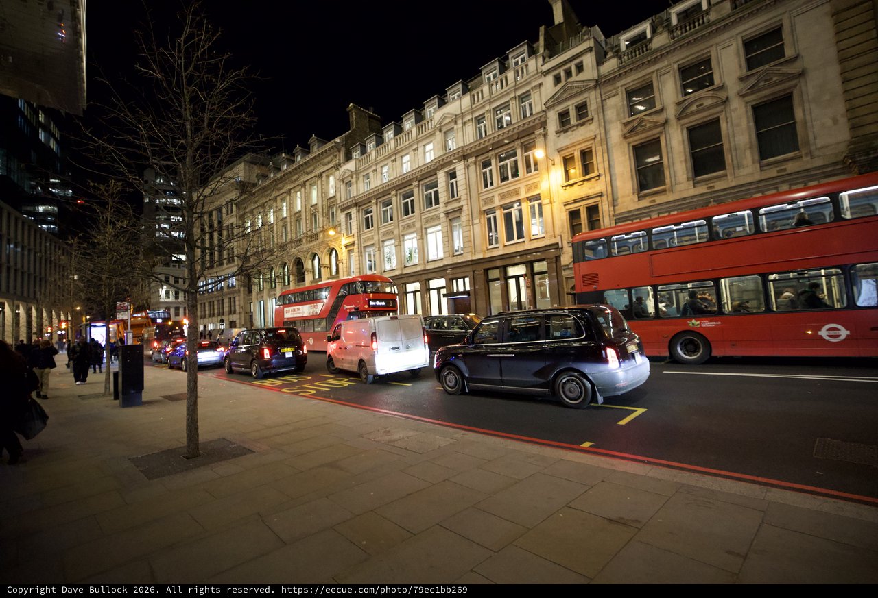 Evening Traffic on London Street with Red Double-Decker Buses