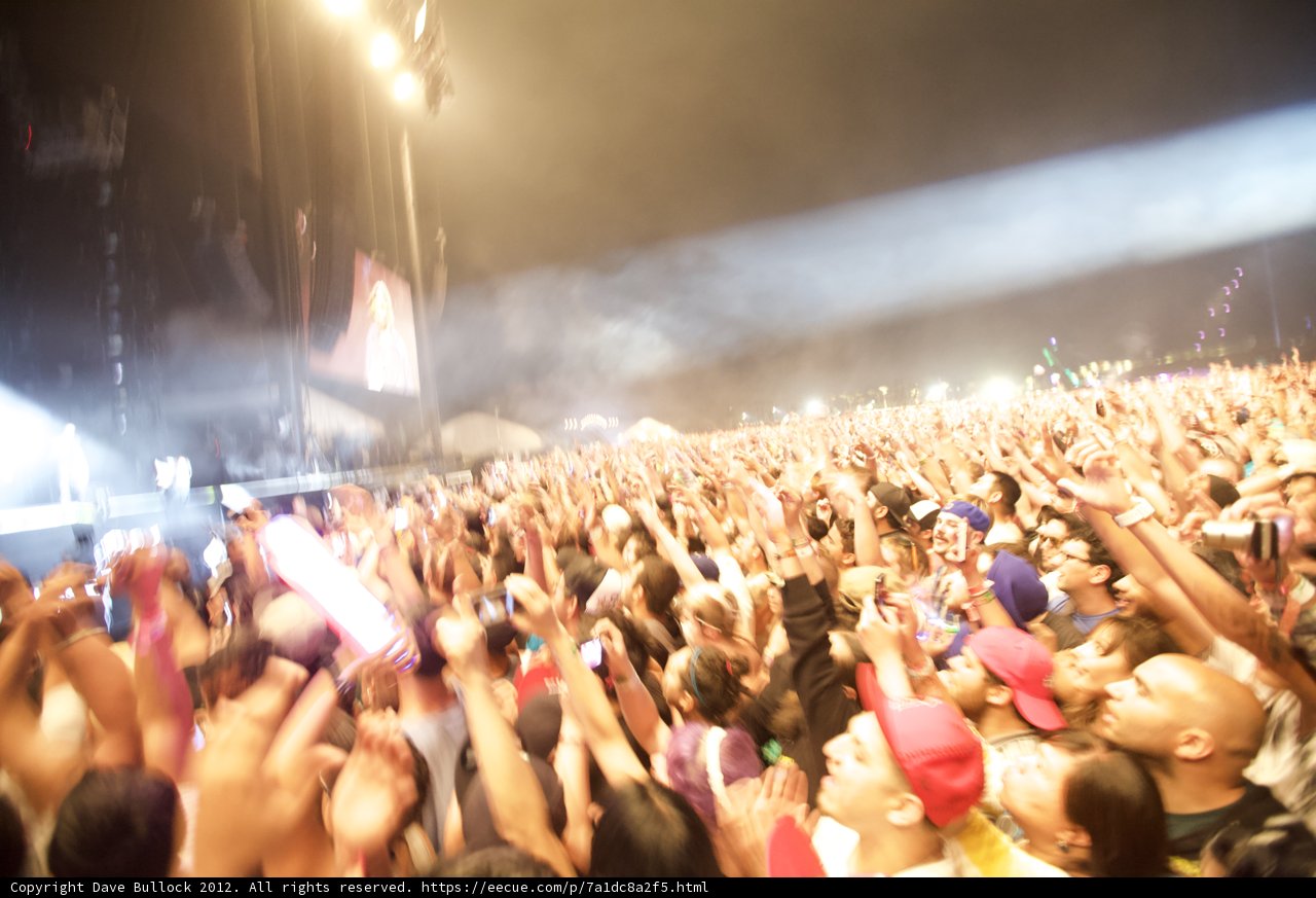 Coachella Crowd Goes Wild Caption: Liu Chunhong and Mick Thomson perform as the audience at Coachella 2012 raises their hands in excitement. The energy and excitement of the concert is palpable as the crowd merges together in one voice.
