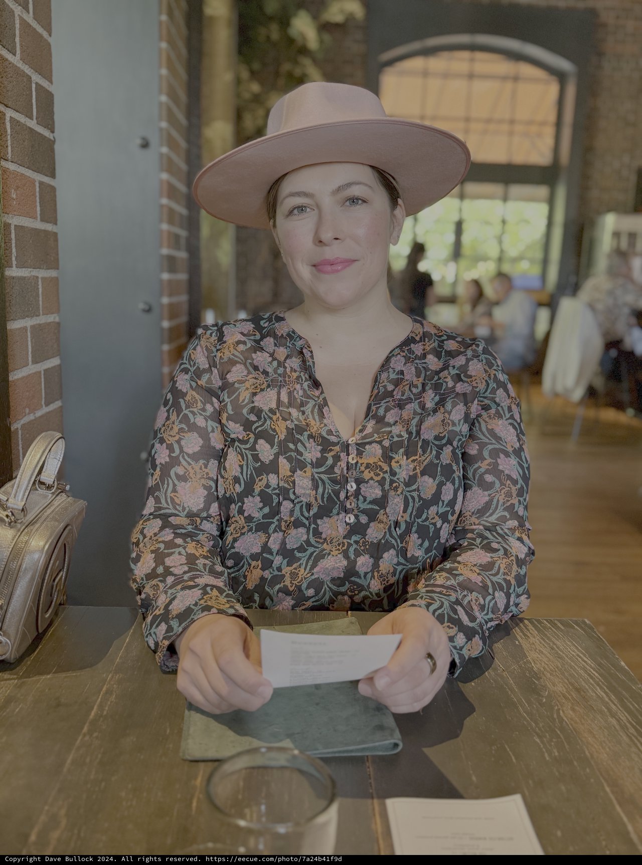 Woman in Floral Blouse at Outdoor Cafe