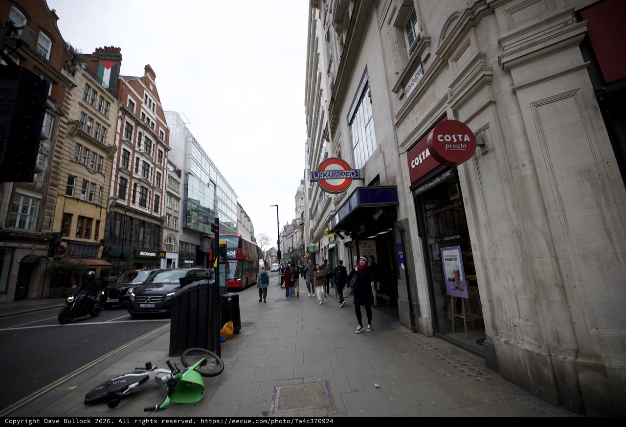Urban Street Scene with Fallen Lime Bike in London