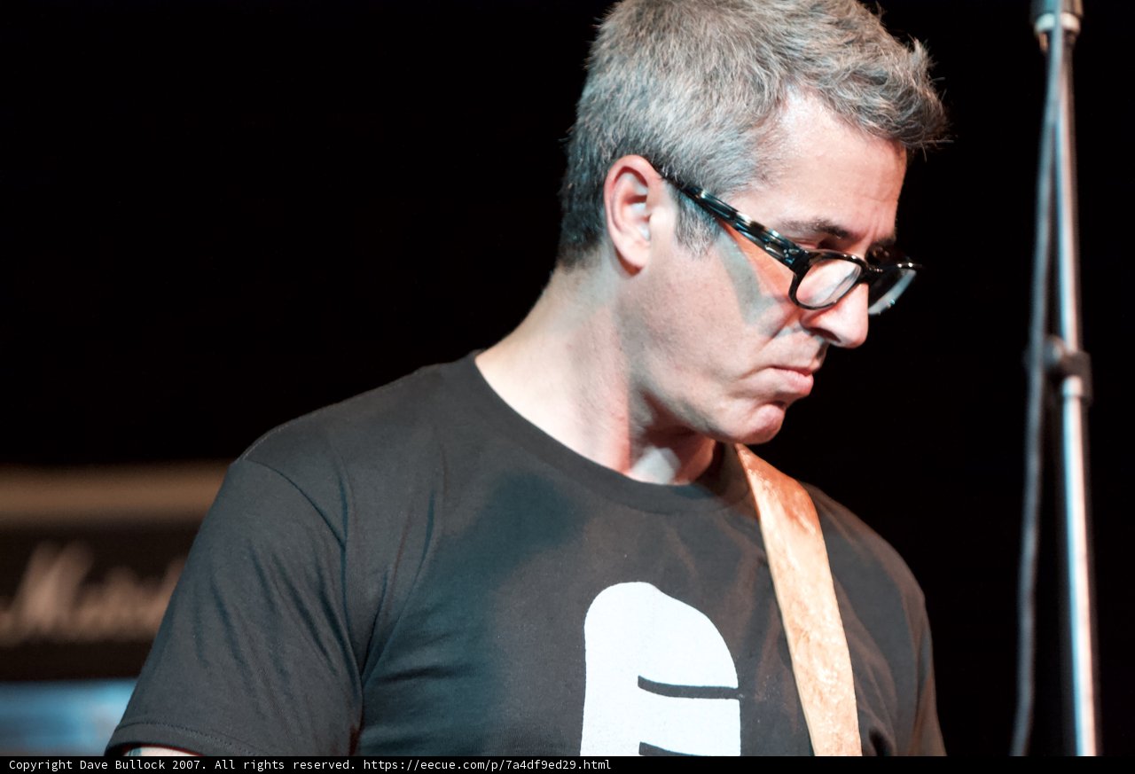 Brett Gurewitz strums his guitar with ease