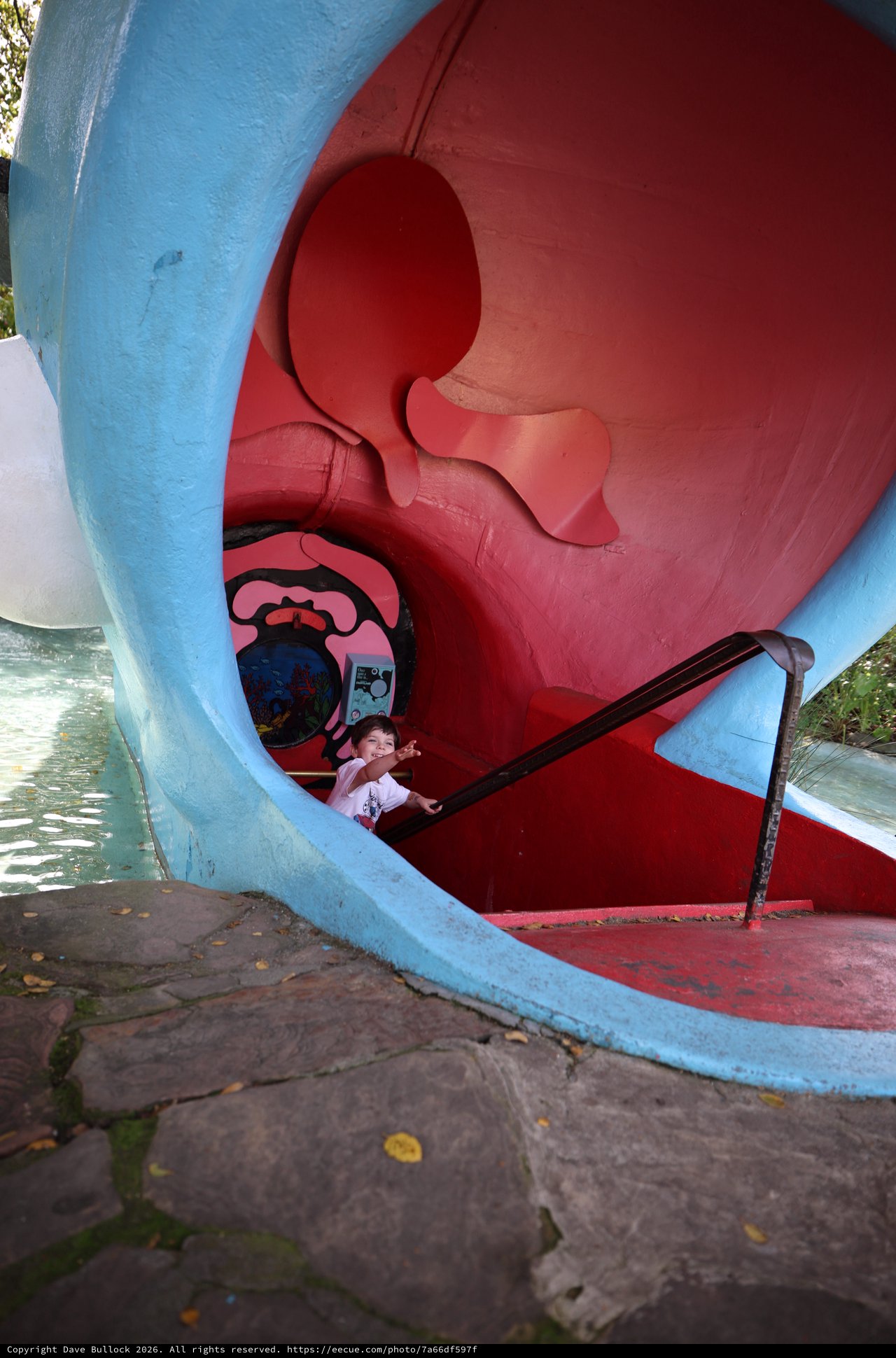 Child Playing Inside Vintage Playground Whale Sculpture
