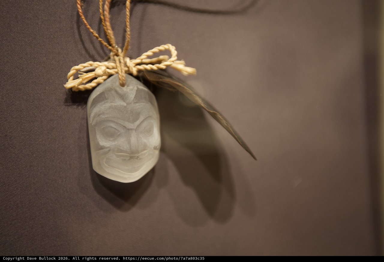 Traditional Carved Pendant with Feather and Rope