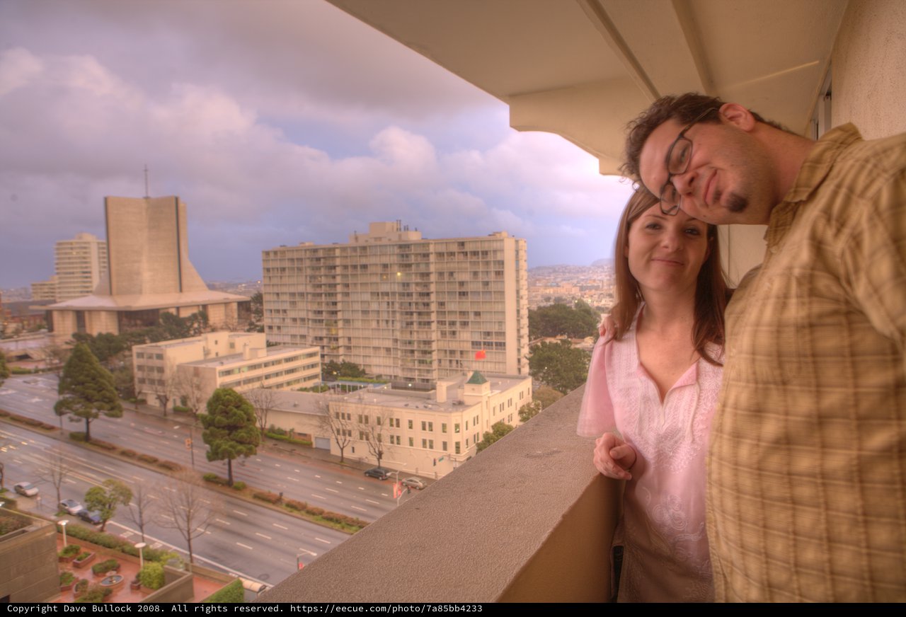 Couple Embracing on Hotel Balcony Over San Francisco