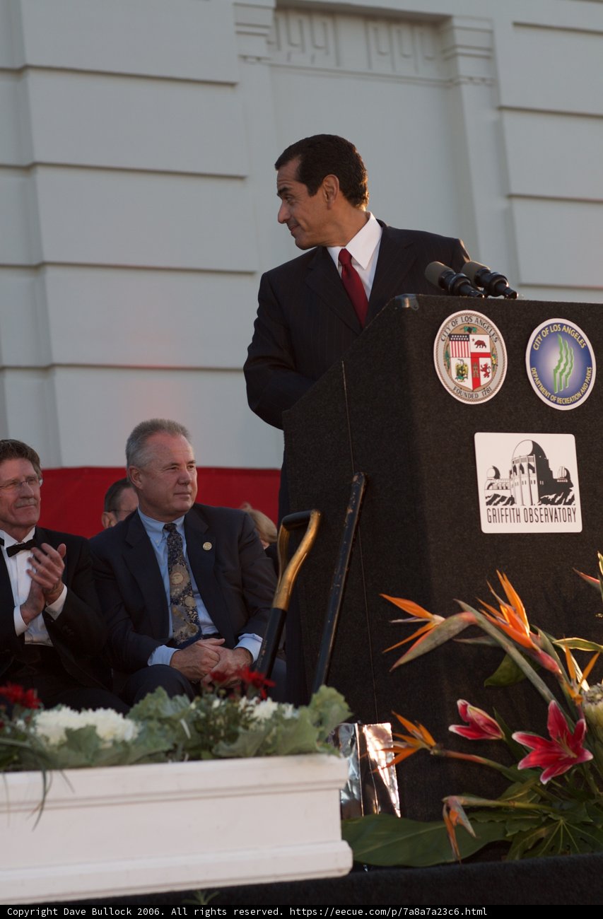 Man Giving Speech at Flower-Adorned Podium