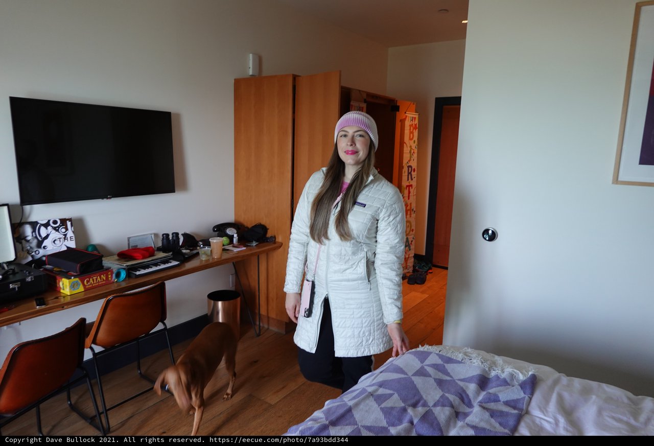 Woman in White Coat Hotel Room Portrait