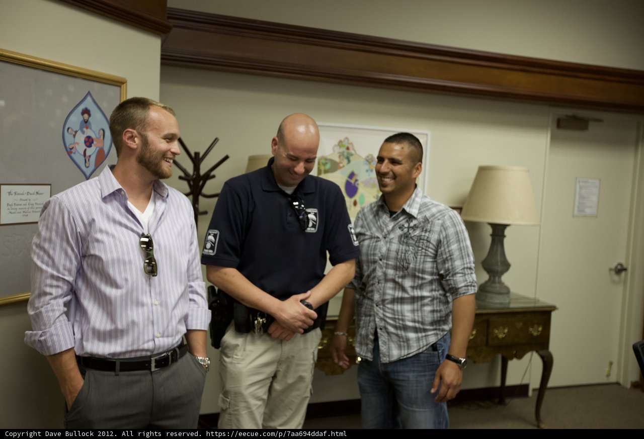 Three Men in an Art-Filled Room