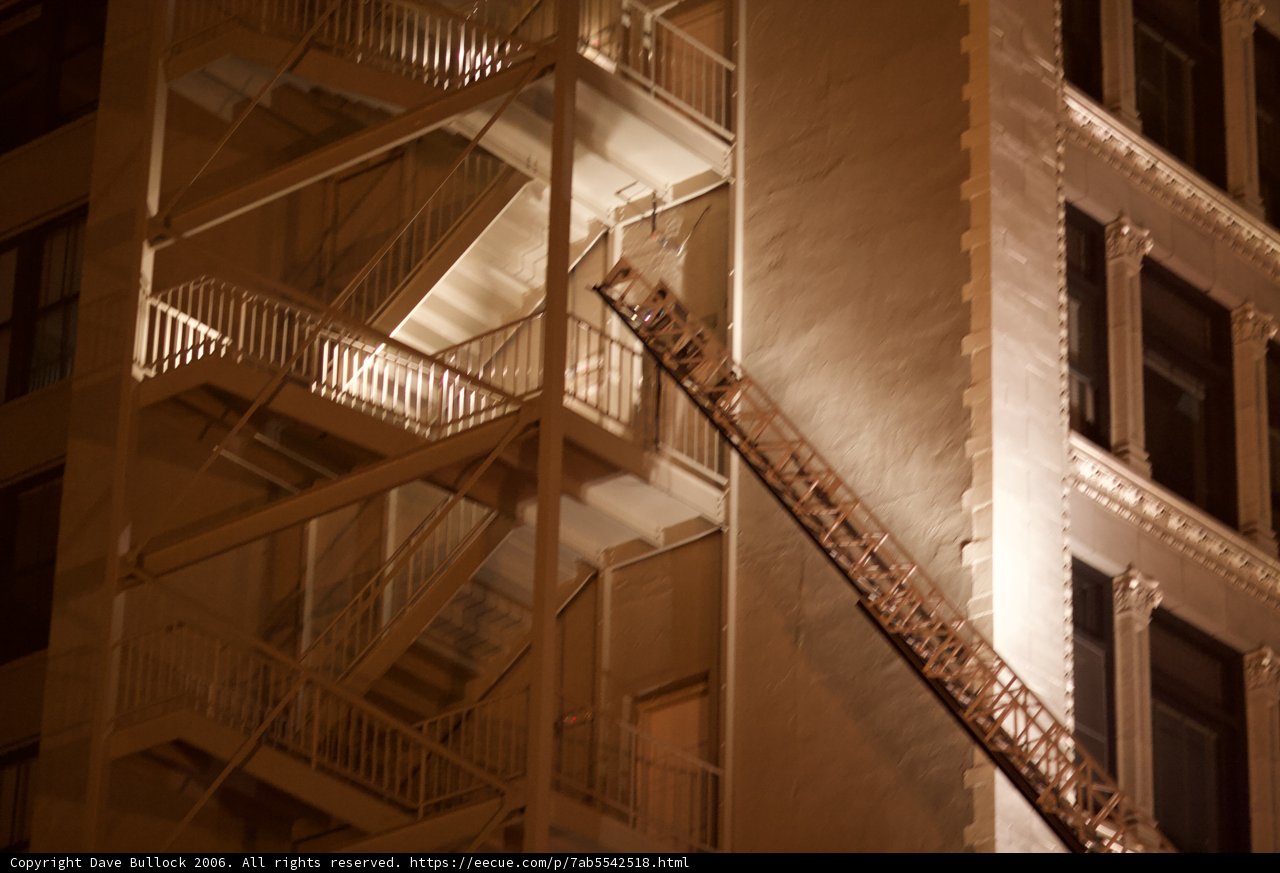 Brave Firefighters Scaling a Building at Night