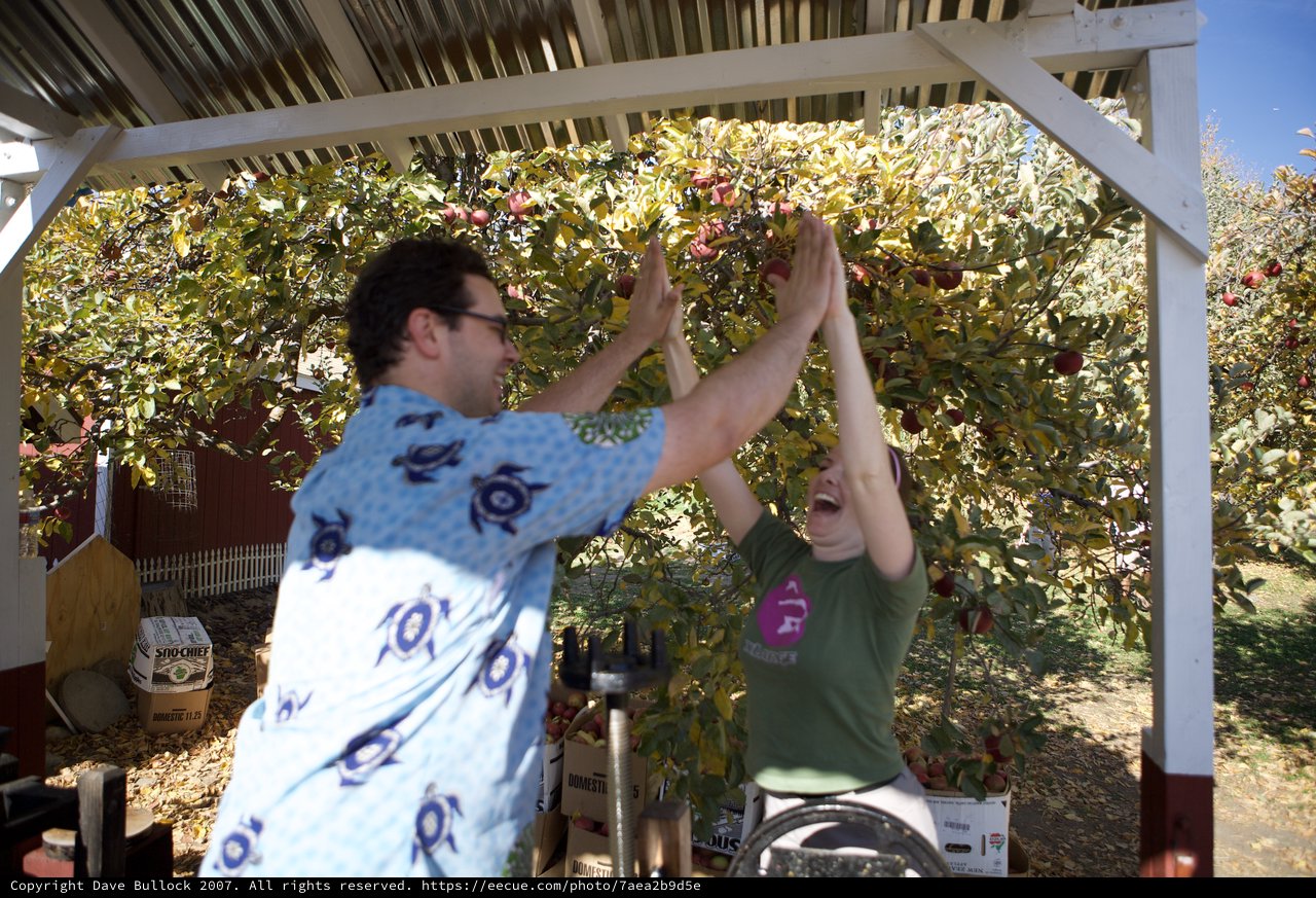 Joyful High Five at Autumn Apple Orchard Harvest